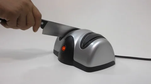 Knife sharpener and hand with a knife. Stock Footage 112293906