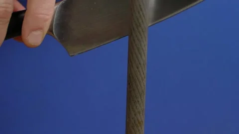 Knife sharpening against blue background Stock Footage 166863346