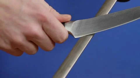 Knife sharpening on flat sharpening tool Stock Footage 166863376