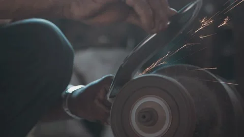 Knife sharpening on a grinder, sparks flying in slow motion Stock Footage 143610997