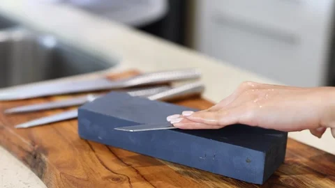 Knife Sharpening on Stone in Kitchen Setting Stock Footage 308501981
