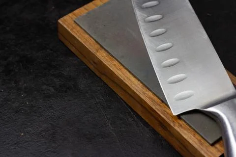 Knife on sharpening stone Stock Photos