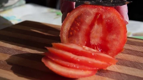 Knife sliced red tomato into thin pieces Stock Footage 75809830