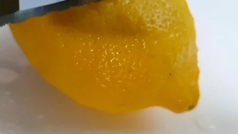 Knife slices a lemon slow-motion shot Stock Footage 89815681
