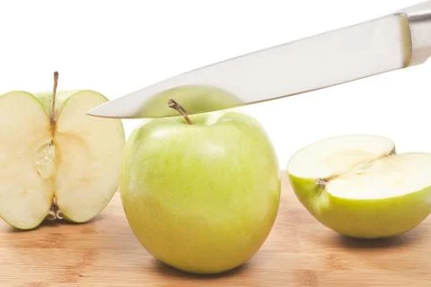 Knife slicing apples on a plank Stock Photos
