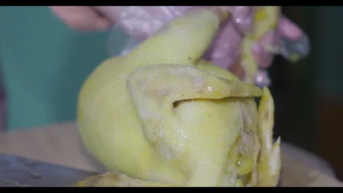 Knife slicing cooked chicken head, close-up, no face Stock Footage 329762733