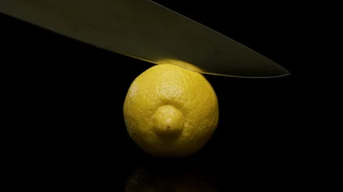 Knife slicing a lemon in half Stock Footage 128720984