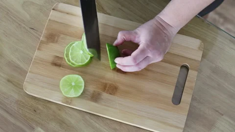 Knife slicing lime top view. Video stock 291764644