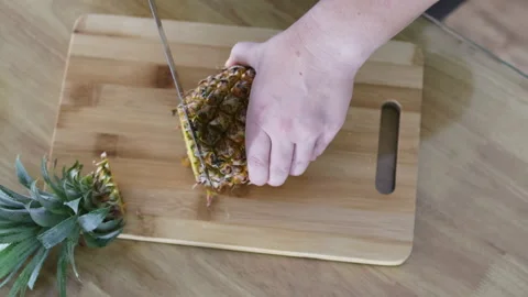 Knife slicing pineapple. Top view. Video stock 291615810