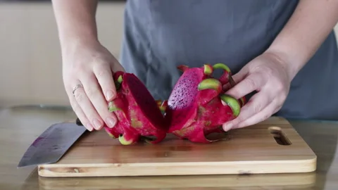Knife slicing red dragon top view. Stock Footage 291765454
