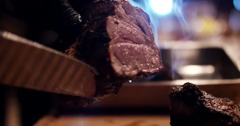 Knife Slicing Steaming Steak in Warm Backlight, Dramatic Barbecue, Macro Shot Stock Footage 340322636