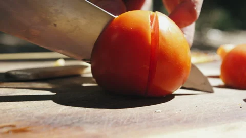 A Knife slicing through tomato Stock Footage 274684034