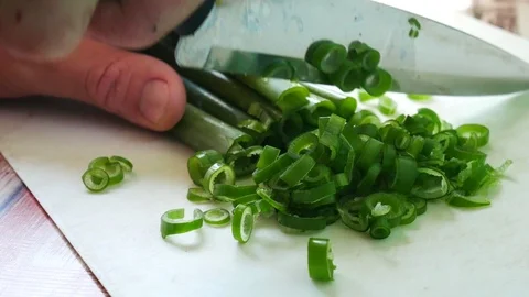 The knife slicks green onions. Cooking the salad. Stock Footage