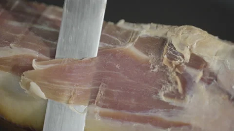 Knife slowly cuts ham, macro shot, 4k Video stock 143655391