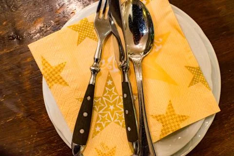 Knife, spoon and fork on a table Stock Photos