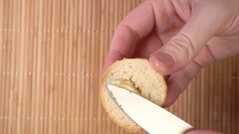 Knife spread butter on bread close up Stock Footage 122311080