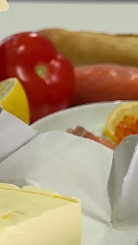 Knife spreading butter on a piece of bread, close up. Spreading cream cheese on Stock Footage 327293882