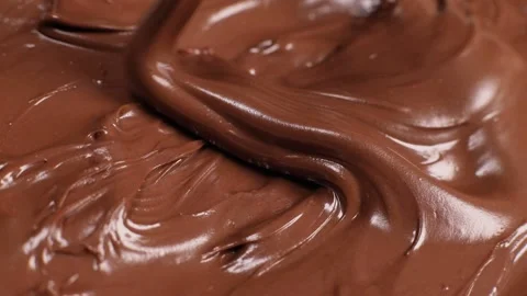 Knife stirs chocolate mass paste with nuts, slow motion Video stock 230179508