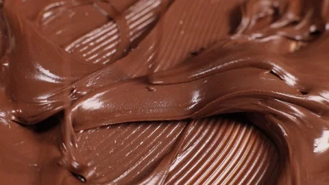 Knife stirs chocolate mass paste with nuts, slow motion Stock Footage 230179662