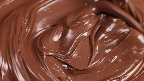 Knife stirs chocolate mass paste with nuts, slow motion Stock Footage 230179769