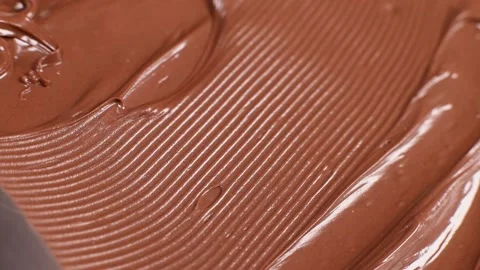Knife stirs chocolate mass paste with nuts, slow motion Stock Footage 230179978