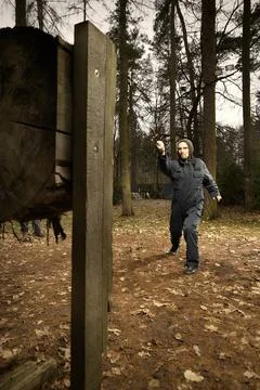 Knife thrower in training session practicing with classic weapon Stock Photos