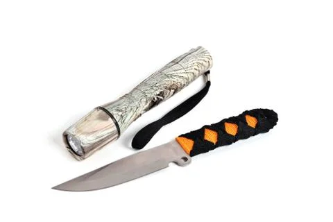 Knife for throwing and hand-held flashlight white background close-up Stock Photos