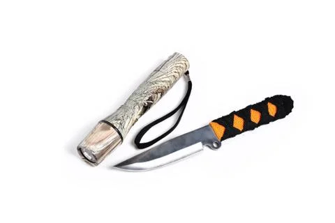 Knife for throwing and hand-held flashlight white background close-up Stock Photos