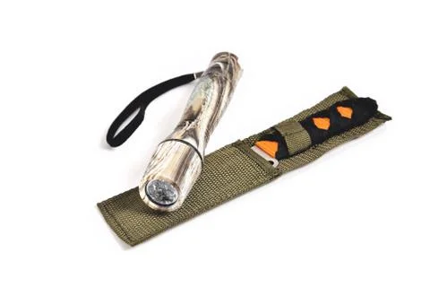 Knife for throwing and hand-held flashlight white background close-up Stock Photos