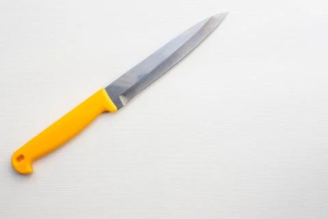 Knife with a yellow handle Stock Photos