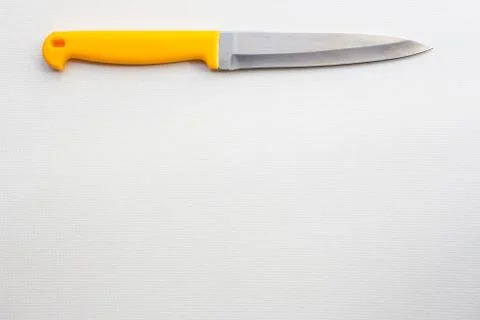 Knife with a yellow handle Stock Photos