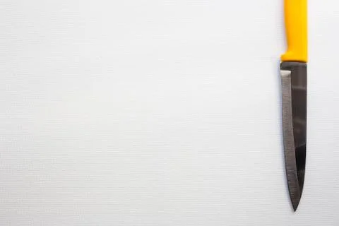 Knife with a yellow handle Stock Photos