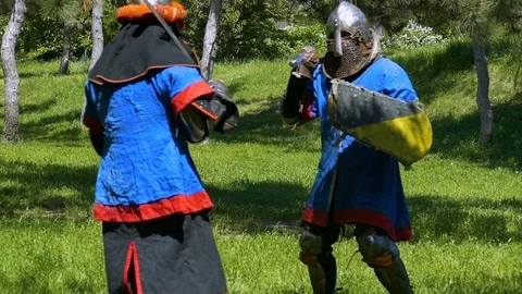 A knight attacks another knight with a shield, another knight attacks with an ar Stock Footage 122079618