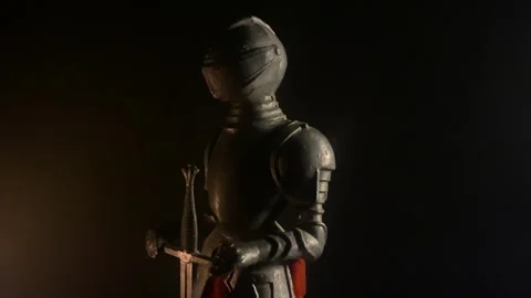 Knight with full suit of armor and sword in the shadows Stock Footage 262189672