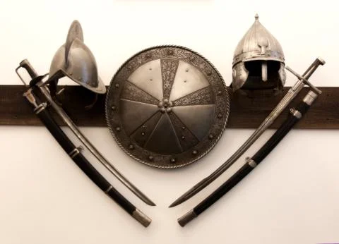Knight helmets swords shield Stock Photos
