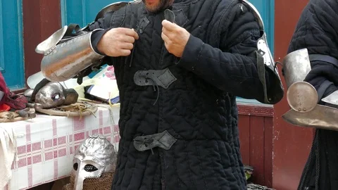 Knight puts on a cloth lining under plate armor Stock Footage 123583845