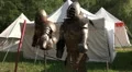 Knight's armor at medieval pageant event white tents HD Footage