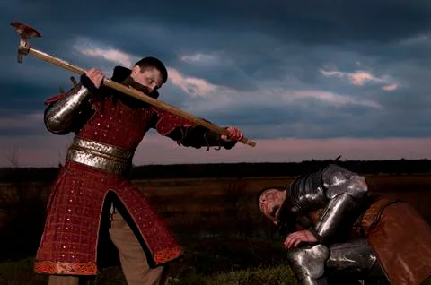 Knights fighting at evening Stock Photos