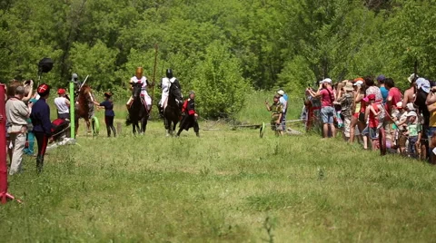 Knights in medieval clothes and helmets riding on horses Stock Footage 64307632