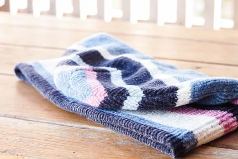 Knit wool hat on wood table Stock-Fotos