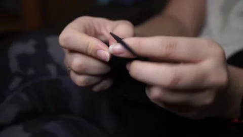 Knits black wool with knitting needles Video stock 169221419