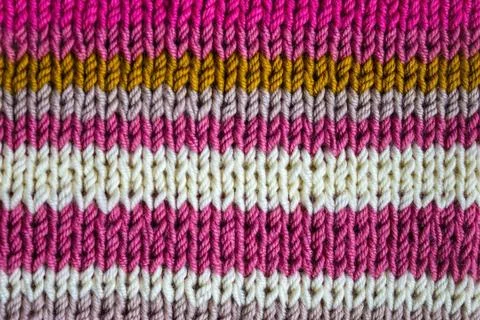 Knitted background of colored stripes. Stock Photos