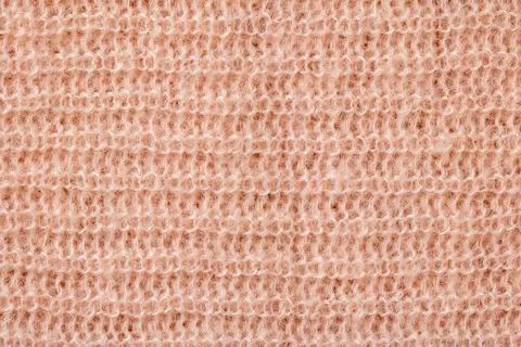 Knitted background. Texture of rough knitting from beige woolen threads Stock-Fotos