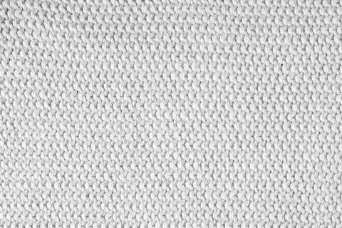 Knitted background.Texture of coarse horizontal knitting from white woolen .. Stock Photos