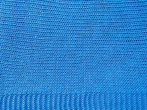 Knitted background.Texture of rough knitting from blue woolen threads Stock Photos
