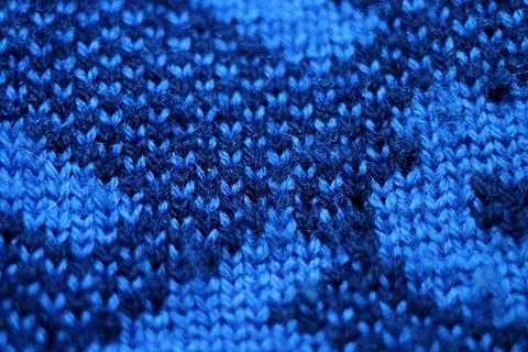 Knitted blue fabric with black pattern Stock Photos