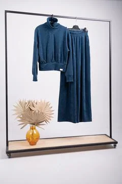 Knitted blue suit hanging on an isolated background Foto stock