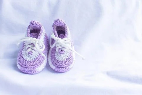 Knitted booties socks on a white background for newborns Stock Photos