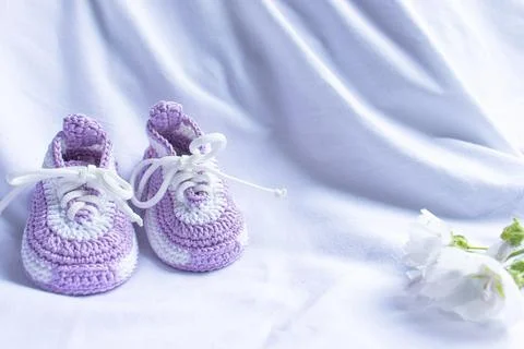 Knitted booties socks on a white background for newborns Stock Photos