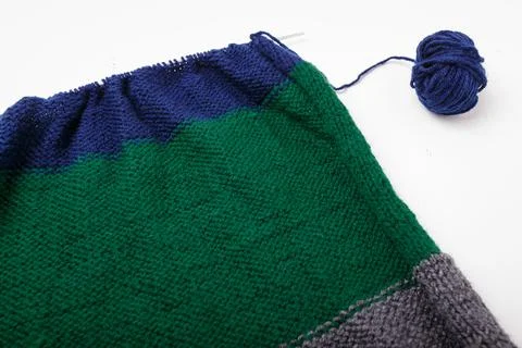 Knitted clothing, accessory in process of making. Knitting needles and ball Stock Photos
